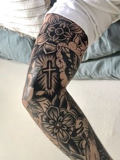 a person with a cross and flowers on their leg