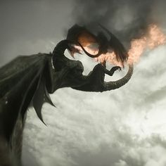 a dragon is flying through the air with its wings spread out and it's mouth open