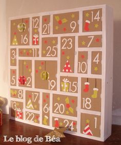 a wooden calendar with numbers and christmas decorations on the front is decorated in brown paper