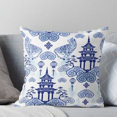 a blue and white pillow sitting on top of a couch