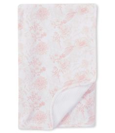 the pink and white floral blanket is folded up