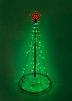 a lighted christmas tree on a green background