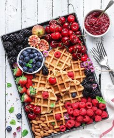 a waffle platter with berries, raspberries, blueberries and cherries