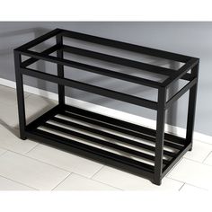 a black shelf sitting on top of a tiled floor