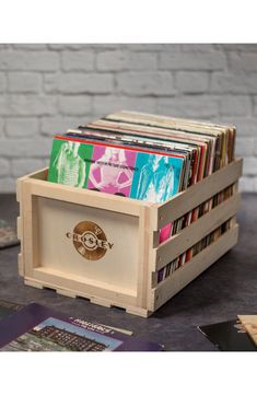 a stack of cds in a wooden crate on a table