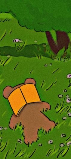 a cartoon bear laying in the grass with an open book on it's back