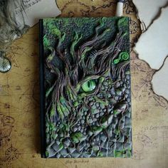 a book with green eyes and vines on it