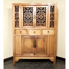 Scholar-Scroll Cabinet was a special piece of furniture in a scholar's study during Ming-Qing dynasty. Scholars might use the lower cabinet for storage of books and paintings; and use the open top cabinet to display their personal collections of jade, stone or snuff bottles etc. The top cabinet doors are decorated with open-carved "lattice and scroll" design. The doors are made with wooden hinge and can be easily removed. The cabinet is handcrafted and structured with wooden pegs and tenon struc Chinese Wardrobe Cabinets, Bar Cabinet Chinese, Chinese Fretwork Pattern, Chinese Apothecary Cabinet, Wooden Hinges, Low Cabinet, Ming Dynasty, Asian Antiques, Scroll Design