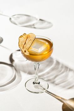 a glass filled with some kind of drink on top of a table