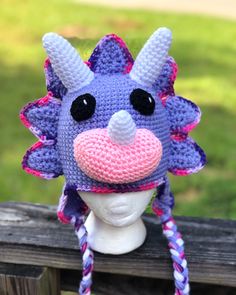 a crocheted purple and pink hat with horns