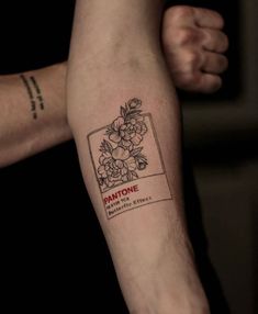 a person's arm with a tattoo on it that reads pantone and flowers