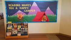 there is a sign on the wall that says reading makes you a happy camper