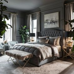 a bedroom with gray walls and carpeted flooring, large bed surrounded by plants