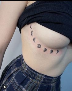 a woman's stomach with phases of the moon on it