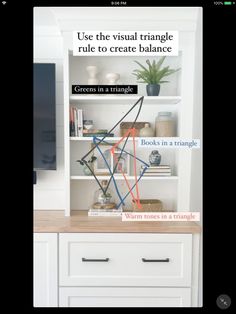 a white bookcase with books on it and a sign that says use the visual triangle to create balance