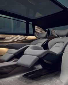 the interior of a modern car with grey seats and leather upholstered backrests