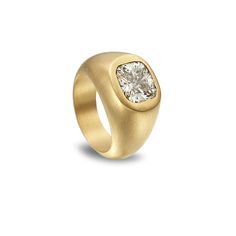 a gold ring with a white diamond in the center and a square shaped stone on top