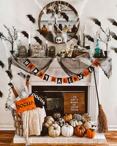 a fireplace decorated for halloween with pumpkins and decorations