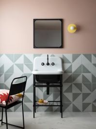 a bathroom with a sink, mirror and chair