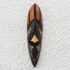 an african mask hanging on the wall