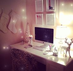 a white desk topped with a computer next to a christmas tree