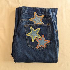 a pair of jeans with embroidered stars on them