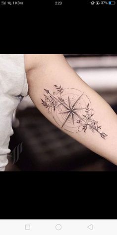 a person with a compass tattoo on their arm