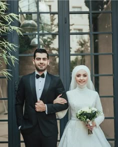 a bride and groom posing for the camera