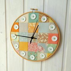 a clock made out of patchwork and buttons