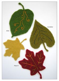 four felt leaf shapes are shown in three different colors, each with an individual's name