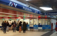 people are standing in line at the train station