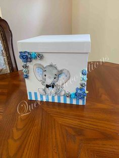 a white box with blue roses and an elephant on it