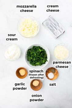 ingredients to make spinach and cheese salad laid out on a white marble counter top