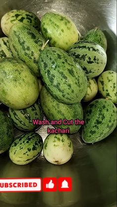 a bunch of watermelons sitting in a metal bowl