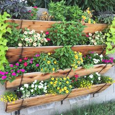 a wooden planter filled with lots of flowers