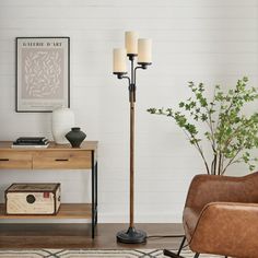 a living room with a chair, table and lamp on the floor next to it