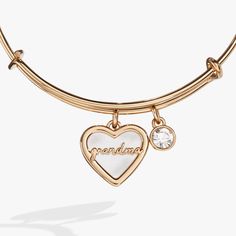 Honor the love and wisdom of your grandmother with this elegant Grandma Mother of Pearl Bangle bracelet, featuring a Mother of Pearl heart charm engraved with the word "Grandma." Mother of Pearl, known for its calming and protective properties, represents the nurturing and unconditional love that grandmothers provide. Paired with a clear crystal charm, symbolizing clarity and light, this bracelet is a beautiful way to cherish the special memories and lasting legacy of your grandma. Whether as a Elegant Grandma, Jewelry Style Guide, Pearl Bangle Bracelet, Glam Gifts, Bar Jewelry, Pearl Bangle, Pearl Heart, Halloween Charms, Alex And Ani Bracelets