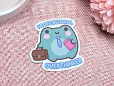 a sticker with the words professional overthiker on it next to a pink flower