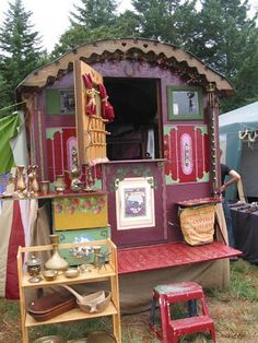 there is a small house made out of wood and other things on display in the yard