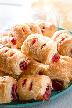 a blue plate filled with pastries covered in jelly