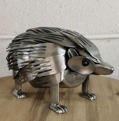 a metal hedgehog sculpture sitting on top of a wooden table