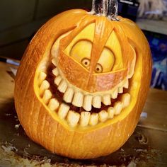 a carved pumpkin with an evil face and teeth