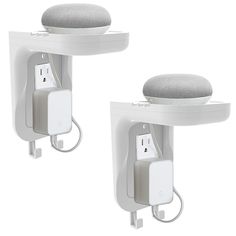 two white wall mounted plugs with one plug on the other and an outlet attached to it