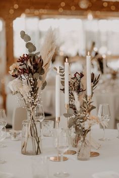 the centerpieces are decorated with flowers and candles