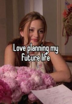 a woman sitting at a table with flowers in front of her and the words love planning my future life