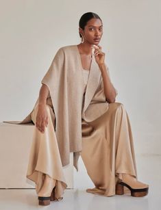 The Baby Alpaca Duster is hand-woven in Chile by Mapuche weavers, to create the perfect specialty poncho. The definition of chic versatility, this piece transitions perfectly from day to night and offers luxurious comfort for any look. 100% Baby Alpaca Model is 5'10", product is One Size Product Care: Dry Clean Only Chic Oversized Cashmere Cape, Chic Cashmere Poncho For Layering, Elegant Beige Poncho For Fall, Elegant One-size Cashmere Poncho, Chic Cashmere Shawl For Fall, Chic Cashmere Shawl, Chic Cape Shawl For Fall, Elegant Oversized Poncho Cape, Elegant Beige Cape Poncho