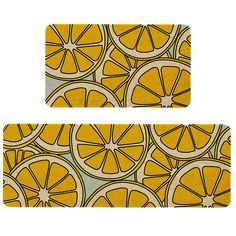 two placemats with orange slices on them, one is yellow and the other is grey