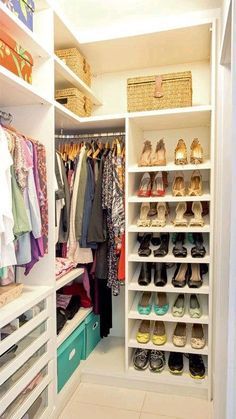 an organized closet with white shelves and drawers filled with clothes, shoes and other items