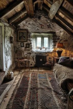 an attic bedroom with stone walls and exposed ceiling, rugs on the floor and bed