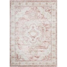 an area rug with pink and beige colors on the floor, including a large medallion design